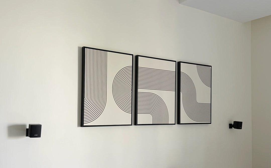 Set of three monochrome geometric art prints displayed on a wall